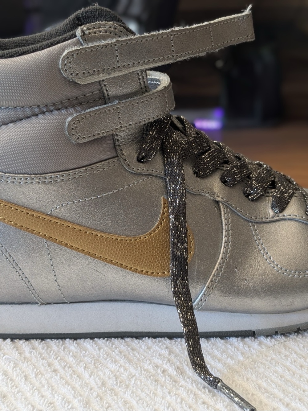 Nike Metallic Gray High-Top Sneaker with Gold Swoosh
